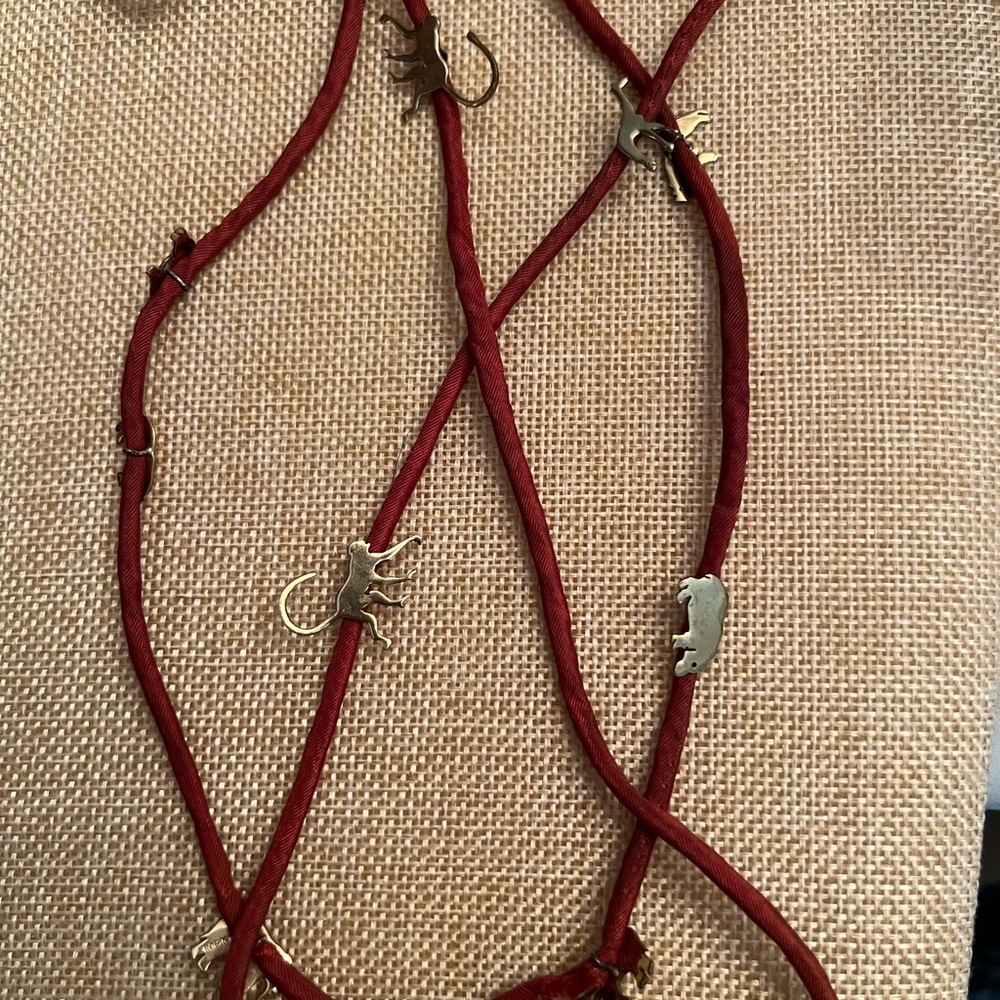 vintage Robin Kahn red cord necklace & charms shaped like various animals.